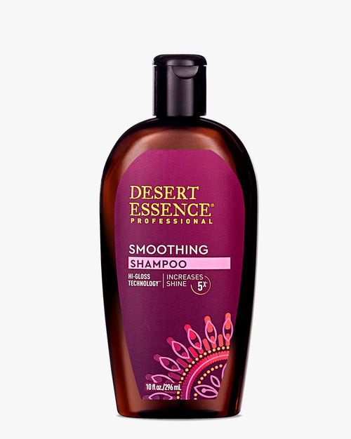 Desert Essence Professional Smoothing Shampoo in a brown bottle with purple label featuring mandala design. Hi-Gloss Technology formula promising 5X shine increase, displayed on elegant professional packaging.