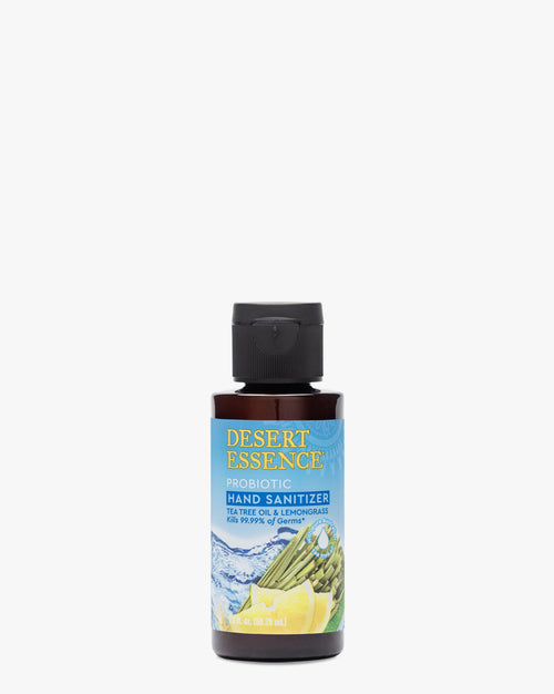 Desert Essence Tea Tree Oil & Lemongrass Probiotic Hand Sanitizer 1.7oz bottle against white background, featuring label with blue waves and lemongrass illustration, natural antibacterial formula in dark brown travel-size container with black flip cap.