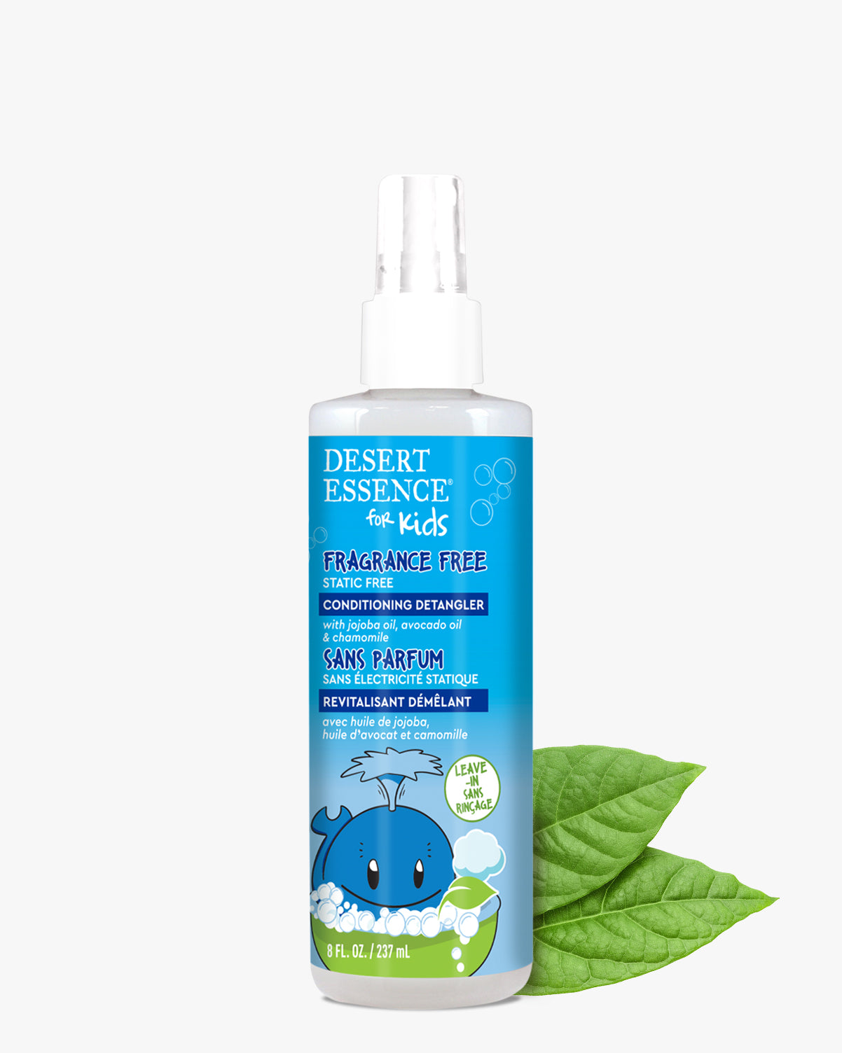 Desert Essence Fragrance Free Conditioning Detangler Spray for Kids 8 fl. oz. in white spray bottle with blue label featuring cute whale illustration, positioned next to fresh green leaves on white background