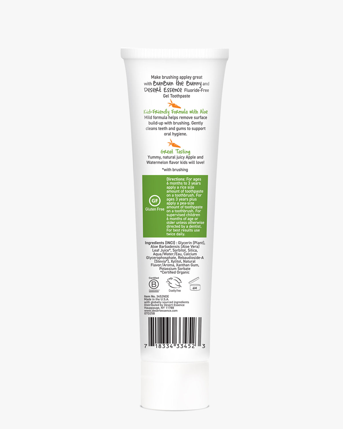 Back of Desert Essence kids toothpaste in white tube with green label on a white background