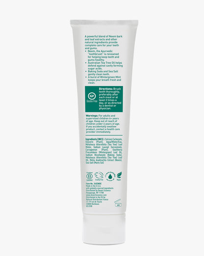 Tube of dental paste with green text on a white background