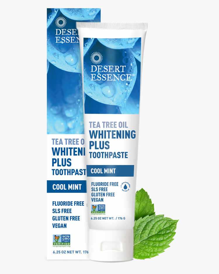 6.25 oz. tube of the Tea Tree Oil Whitening Plus Toothpaste Cool Mint with mint leaves and packaging by Desert Essence.