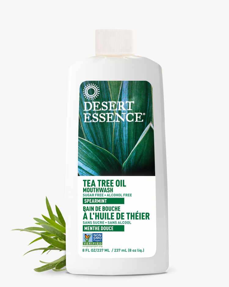 8 Fl. oz. bottle of the Tea Tree Oil Mouthwash Spearmint with spearmint leaves by Desert Essence.